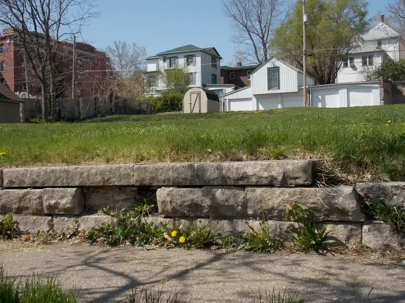 Terraced limestone block retaining walls in a front yard